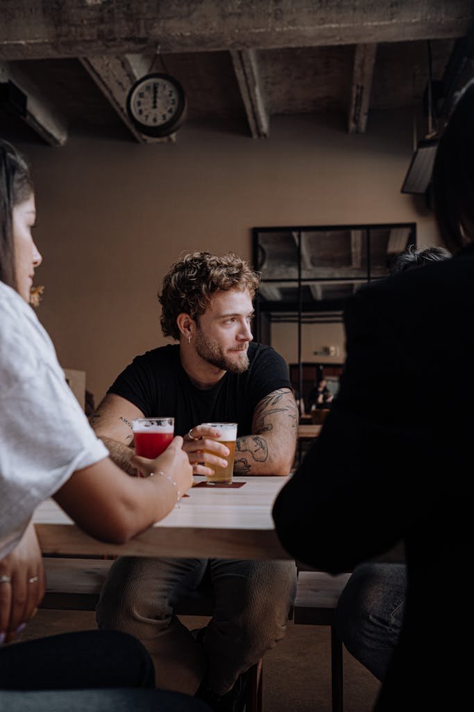 Group of friends sharing drinks at a rustic pub, enjoying different craft beers.